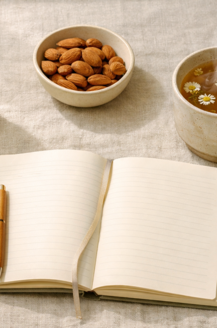 Detailed () editorial image showing a flat-lay overhead composition of a woman's energy reset toolkit on a linen surface: a